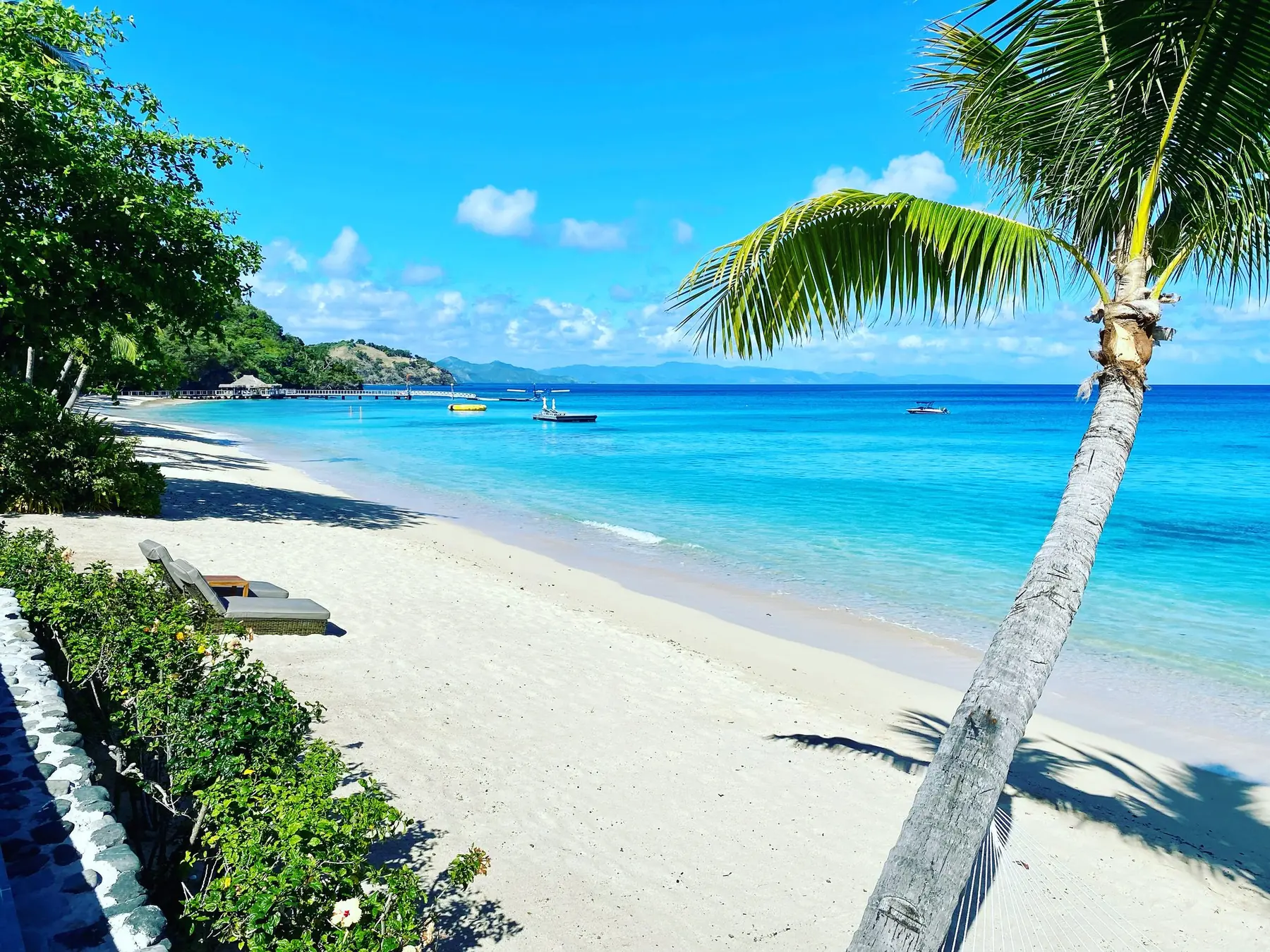 Palm-shaded white sand beach at Kokomo Island, Fiji