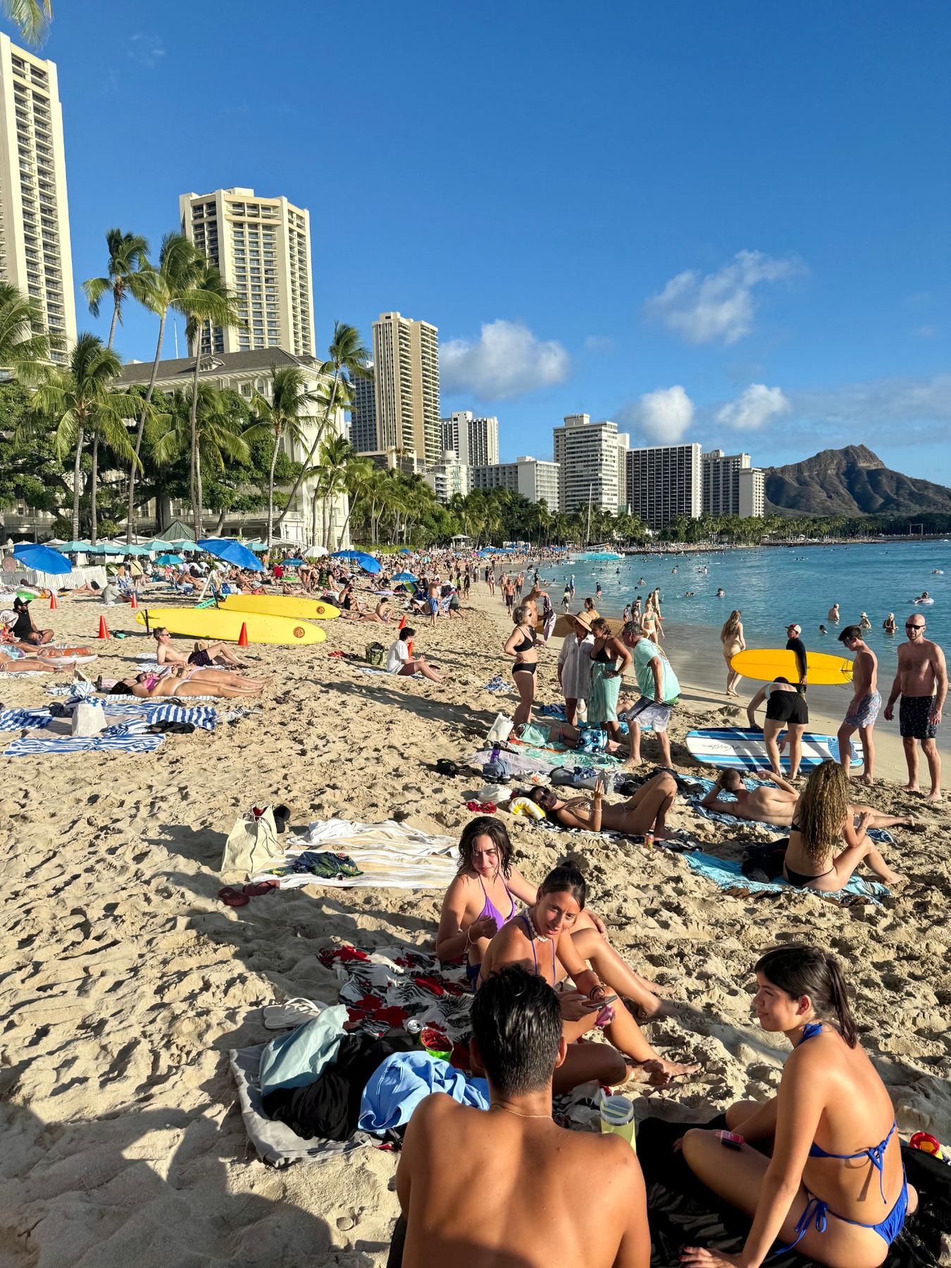Waikiki Beach with surfboards, high-rises and Diamond Head in the distance